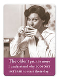 A woman with short, dark hair sips from a teacup, looking at the camera. Caption: The older I get, the more I understand why roosters scream to start their day. Roosters Magnet by Shannon Martin Design—ideal for vintage magnet collections.