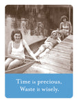 Three smiling women in swimsuits relax by a dock—two in a canoe, one by lockers. The caption: Time is precious, Waste it wisely. Shown: Time Is Precious Magnet by Shannon Martin Design.