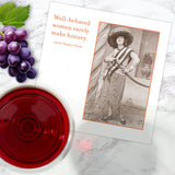 A wine glass, grapes, a vintage photo card, and Shannon Martin's Well Behaved Napkin for bold, history-making women.