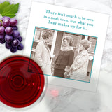 The Small Town Napkin by Shannon Martin Design features a vintage photo of three women talking outside and the phrase: "There isn’t much to be seen in a small town, but what you hear makes up for it.