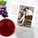 A greeting card features a vintage photo of a laughing woman with wine and bottles, captioned: “You bring the alcohol, I'll bring the bad decisions.” Pair it with Shannon Martin Design’s Bad Decisions Napkin for your next toast!.