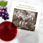 The Men Have Feelings Napkin by Shannon Martin Design is a white biodegradable beverage napkin featuring a vintage photo of two men toasting, captioned: "Men have feelings, too. Sometimes they feel thirsty." Grapes and wine on marble nearby.