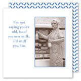 A smiling elderly woman with glasses and an apron holds a milk bottle in front of the fridge. "I’m not saying you’re old, but if you were milk, I’d sniff you first." Cream Of The Crop Napkin by Shannon Martin Design—vintage fun!.