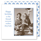 Two women in vintage western attire sit on a wooden fence, waving hats in the air. Next to them: "Happy birthday to the friend everyone wishes they had." Blue floral border. Hats Off Napkin by Shannon Martin Design.