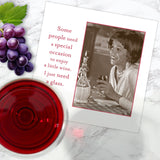 A Shannon Martin Design "Special Occasion Napkin" is shown on a marble surface with grapes, red wine, and a card featuring a smiling woman holding a glass and the quote: "Some people need a special occasion to enjoy wine. I just need a glass.