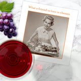 A glass of wine, grapes, a woman's photo, and Shannon Martin Design's What A Friend Napkin—biodegradable beverage napkins that make the perfect party supplies for your next gathering.