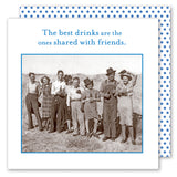 Eight friends smiling outdoors with drinks and Shannon Martin Design's The Best Drinks Napkin—because the best drinks are shared.