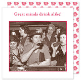 A group of women at a bar laughs together holding Shannon Martin Design's "Great Minds Drink Alike" napkins.