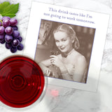 The Not Going To Work Napkin by Shannon Martin Design features a vintage photo of a woman holding a drink with the caption “This drink tastes like I’m not going to work tomorrow.” Ideal for hostess gifts and entertaining.