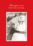 A cheerful individual in winter clothing embraces a big snowman on a snowy day, captured in a vintage-style photo with a decorative border. At the top, white text pops on a red background with the message: "Love you to the North Pole and back." This holiday card is from Shannon Martin Design, called the North Pole Holiday Card.