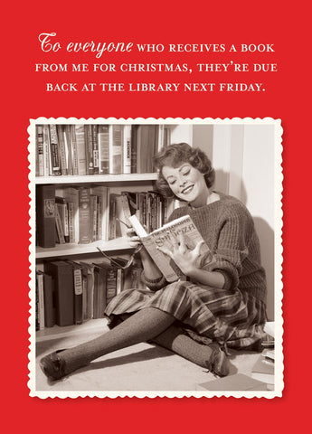 The Library Holiday Card by Shannon Martin Design features a vintage-style photo of a smiling woman reading by a bookshelf with a funny reminder to return Christmas books. Made in the USA from FSC-certified, recycled paper.