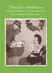 A man gives a wrapped gift to a smiling woman on a bench amid festive decor. The text jokes she shopped after cocktails, so the gift surprises her too—perfect for a playful holiday greeting. Surprise Holiday Card by Shannon Martin Design, made in USA.