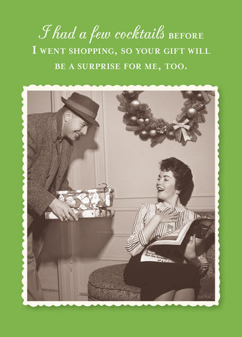 A man gives a wrapped gift to a smiling woman on a bench amid festive decor. The text jokes she shopped after cocktails, so the gift surprises her too—perfect for a playful holiday greeting. Surprise Holiday Card by Shannon Martin Design, made in USA.