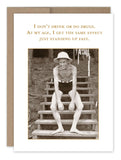 The "Standing Up Fast Birthday Card" by Shannon Martin Design features a vintage black and white photo of an elderly man in a hat and swim trunks, sitting on outdoor steps. Above him, the humorous text reads: "I don‚Äôt drink or do drugs. At my age, I get the same effect just standing up fast," like evoking nostalgia from a kraft envelope.
