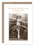 A vintage photo of a performer in an elaborate costume adorned with beads and floral elements is featured on recycled paper, along with the quote by Oscar Wilde: "Be yourself. Everyone else is already taken." This unique piece comes as the "Be Yourself Birthday Card" from Shannon Martin Design.