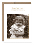 A sepia-toned image of a young child smiling and hugging themselves is set against a foliage backdrop. The text above reads, "Sometimes a hug is the best medicine." This "Hug Best Medicine Get Well Card" by Shannon Martin Design features a brown border reminiscent of vintage photographs and is crafted on recycled paper made in the USA.