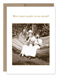 Two women relax on a hammock outdoors, each holding a bottle, with the text "Why limit happy to an hour?" above them. This charming scene is featured on the front of the Happy Hour Birthday Card by Shannon Martin Design, crafted in the USA using recycled paper.
