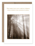 The "Gained An Angel Sympathy Card" by Shannon Martin Design is crafted from recycled paper and showcases a sepia-toned image of sun rays filtering through a forest. The card features the heartfelt message, "The world has lost a special person, while heaven has gained an angel." It is proudly made in the USA.