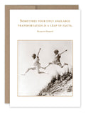 The Leap Encouragement Card from Shannon Martin Design showcases a sepia-toned photograph of two children leaping over a sand dune. The card displays the text, "Sometimes your only available transportation is a leap of faith," with Margaret Shepard's name printed below on recycled paper.