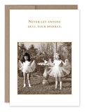 Shannon Martin Design's "Your Sparkle Birthday Card," crafted with nostalgia in the USA, showcases a vintage photo on recycled paper. It features two young girls joyfully posing in tutus within a garden, accompanied by the uplifting gold-lettered message, "Never let anyone dull your sparkle.