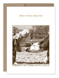 A sepia-toned photo of a child feeding a cow from a bottle exudes vintage charm. The child, dressed in a checkered shirt and jeans, is standing on the farm. Above this nostalgic image, the words "MOO-CHAS GRACIAS" are printed, making it an ideal choice for Shannon Martin Design's Gracias Thank You Card made from recycled paper.