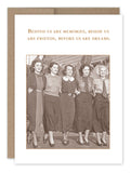 A Shannon Martin Design "Behind Us Birthday Card" features a vintage photo from Shannon's collection, capturing five women walking arm in arm and smiling. They are dressed in mid-20th century dresses and heels. Above them is the phrase: "Behind us are memories, beside us are friends, before us are dreams." The card is printed on recycled paper with a brown border.