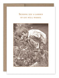 The Garden Get Well Card by Shannon Martin Design showcases a vintage sepia-toned image of a young child in a floral dress, enjoying the scent of flowers in a garden. The card features the message "Sending you a garden of get well wishes" and comes in Shannon's signature envelope, adding an extra touch of charm. It's printed on recycled paper for an eco-friendly choice.