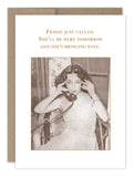 The "Friday Just Called Birthday Card" by Shannon Martin Design showcases a vintage aesthetic with a black-and-white photograph of a woman on a rotary phone, seated in a wicker chair. The card's text playfully announces, "Friday just called. She'll be here tomorrow and she's bringing wine." It is printed on recycled paper and comes with a Kraft envelope for an added nostalgic touch.