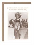 Sepia-toned image of a woman from the 1950s, smiling in a bathing suit and large sun hat while sitting on a ledge. The vintage photo features the caption, "Just because it's a bad idea doesn't mean it won't be a good time," as featured on the Good Time Birthday Card by Shannon Martin Design.