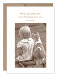 The Love Of A Cat Friendship Card by Shannon Martin Design features a sepia-toned image of a child with short hair sitting on a stool beside a cat, accompanied by Dickens' quote, "What greater gift than the love of a cat." Ideal for nostalgia enthusiasts, it comes packaged in an eco-friendly Kraft envelope made from recycled paper.