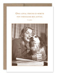 A woman happily hugs a dog in a sepia-toned photograph. Above them, the text states: One loyal friend is worth ten thousand relatives. - Euripides. The image adorns the One Loyal Friend Friendship Card by Shannon Martin Design, crafted from recycled paper and paired with a plain brown Kraft envelope.