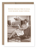 In a vintage-style scene, a woman in a dress sits in a chair reading an FSC-certified magazine. Behind her is a fan and window. The text above her reads, "Anyone who has time to clean is not reading nearly enough." 
Introducing the "Time To Clean Birthday Card" by Shannon Martin Design.
