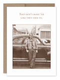 A greeting card from Shannon Martin Design features a vintage photo of a person leaning against an old car, with the text "They don't make 'em like they used to" above the image. The card, titled "A True Classic Birthday Card," is printed on recycled paper.