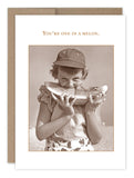 The Melon Thank You Card from Shannon Martin Design features a charming sepia-toned image of a child in a cap, happily enjoying a large slice of watermelon. Above the delightful vintage photo, the text reads "You're one in a melon." This nostalgic piece is printed on recycled paper.