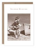 The "We Got This Friendship / Just Because Card" by Shannon Martin Design features a sepia-toned image of two children on a beach, pulling a small rowboat, with the caption "You and me. We got this." It beautifully captures the charm of vintage photographs and looks lovely when placed in a kraft envelope or printed on recycled paper.