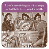 Three women in vintage clothing sit at a bar, each with cigarettes and drinks resting on Shannon Martin Design's Glass Half Full Coasters. A humorous sign above them reads, "I don‚Äôt care if the glass is half empty or half full. I still need a refill.