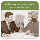 A vintage-style image of a man and woman at a table toasting with martini glasses, resting on cork-based Shannon Martin Design's "Worth A Shot Coaster." The coaster reads, "Vodka may not be the answer, but it's worth a shot," making it the perfect heat and water resistant hostess gift.