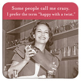 A vintage-style image features a woman smiling while shaking a cocktail shaker in a bar. Above her, the caption reads, some people call me crazy; I prefer the term happy with a twist. This Shannon Martin Design product, "Happy With A Twist Coaster," is perfect as a hostess gift or when paired with cork-based coasters for added heat and water resistance.