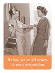 Two women in vintage outfits are smiling and interacting cheerfully near a row of lockers in the hallway. One holds a handbag. A caption below reads, "Relax, we're all crazy. It's not a competition." - Shannon Martin Design's We're All Crazy Magnet.