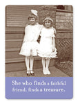 In a vintage photo featured on the "Faithful Friend Magnet" by Shannon Martin Design, two young girls in white dresses and headpieces stand arm in arm on sturdy wooden steps, smiling. Below the image, a quote reads, "She who finds a faithful friend finds a treasure.