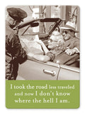 A vintage photo on the Shannon Martin Design's "Road Less Traveled" Magnet shows a smiling couple in a convertible holding a map, with a uniformed man beside them. The text overlay humorously states, "I took the road less traveled and now I don‚Äôt know where the hell I am," reminiscent of searching for directions in an old file cabinet!