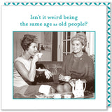 A vintage-style photo of two women sitting on a couch, sipping tea. One wears a dress and pearls, and the other is in a fur hat and coat, holding Shannon Martin Design's Same Age Beverage Napkin. The caption reads, "Isn't it weird being the same age as old people?