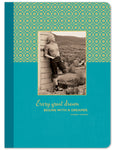 Dressed in vintage attire, a woman leans against wood with mountains behind her. The Every Great Dream Journal by Shannon Martin Design features a teal, patterned cover with gold foil, showcasing the Harriet Tubman quote: Every great dream begins with a dreamer.